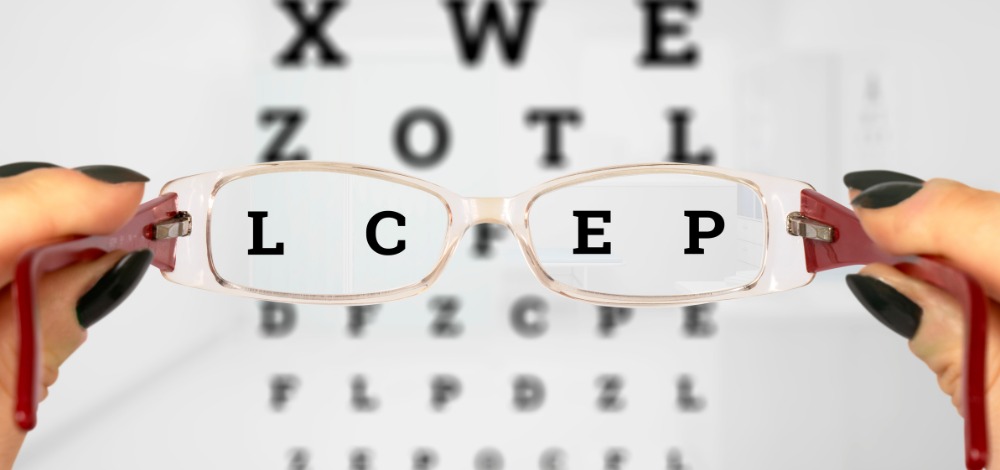 A Pair of Eyeglasses With an Eye Chart in the Background