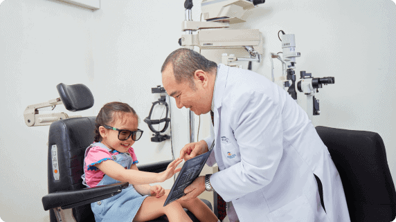 an ophthalmologist checking the eye sight of a girl