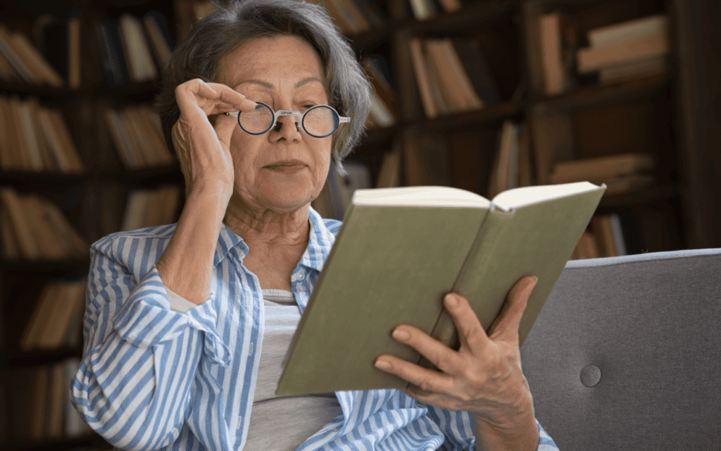 an elderly woman reading a book