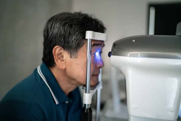 Senior man doing an eye exam in a medical clinic