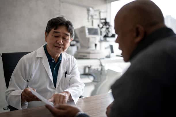 Doctor talking to patient showing eye exams during medical appointment