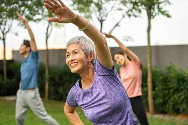 Diverse people exercising dancing zumba outdoor in city park