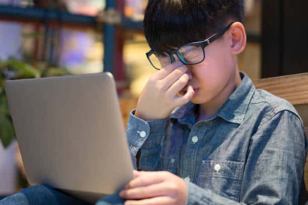a young student suffering from tired eyes