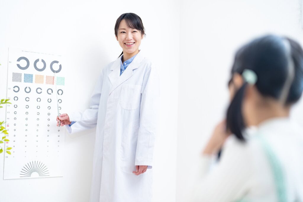 an ophthalmologist doing eye exams to a young girl