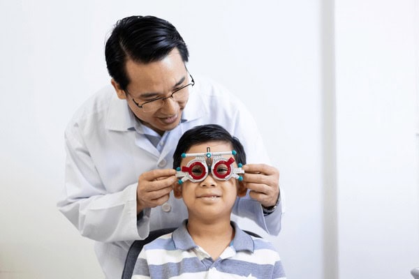 asian-ophthalmologist-examines-childs-vision