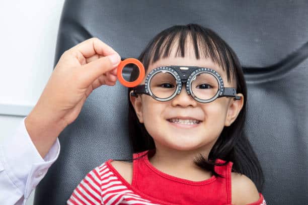 Asian Little Chinese Girl Doing Eyes Examination at An Optical Shop