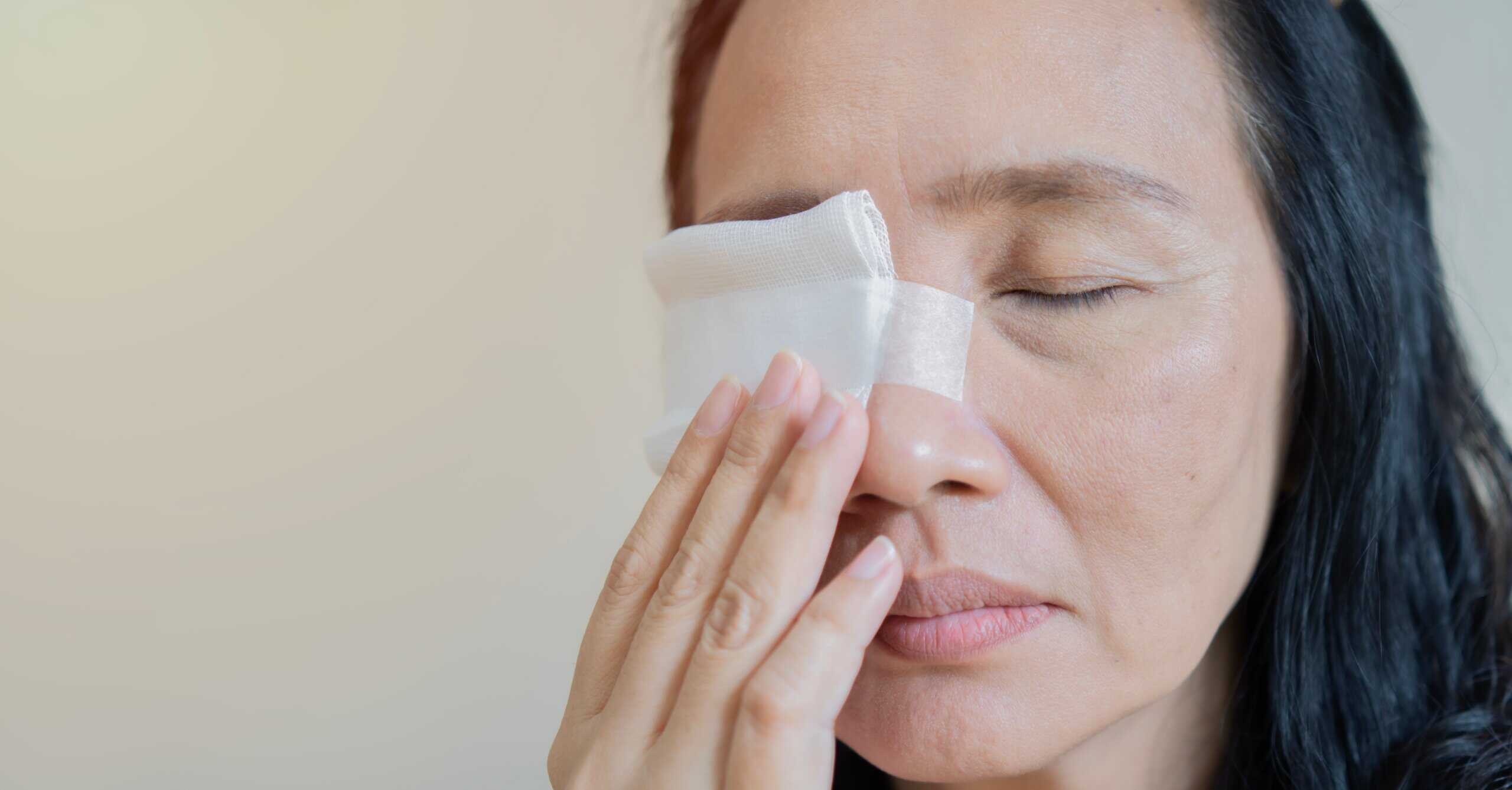 an elderly woman recovering from eye surgery