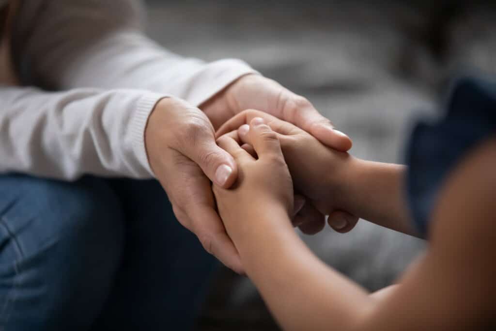 two people reaching out to one another
