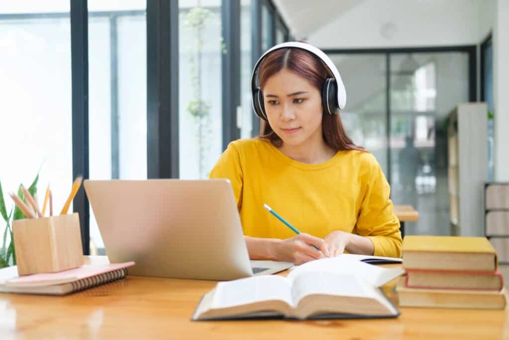 a young woman studying and taking notes