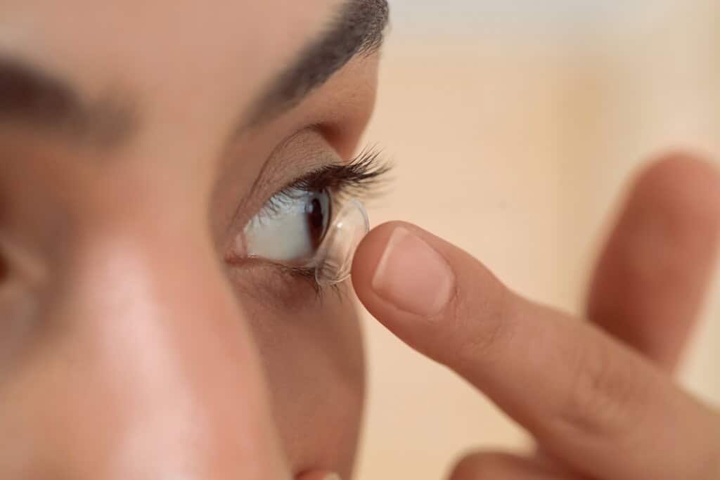 a teenage girl putting contact lens