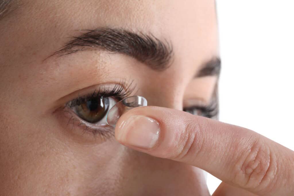 a woman putting in contact lens