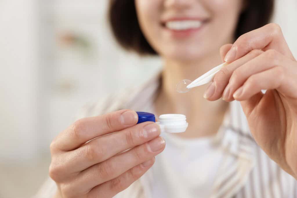 a woman taking contact lens out