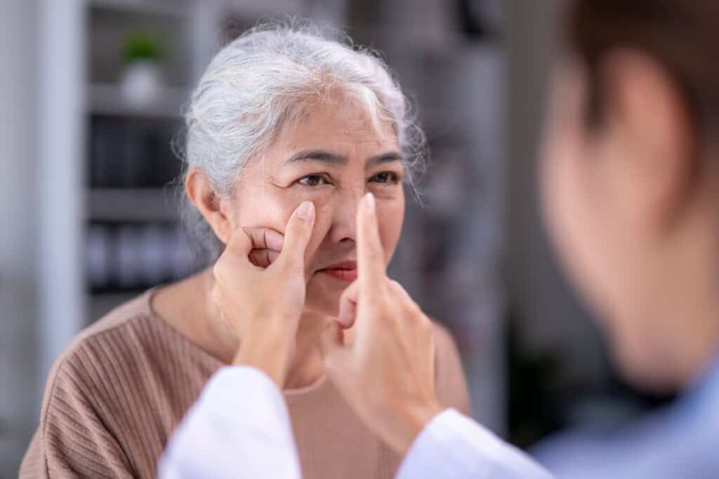 a doctor examining an elderly patient's vision