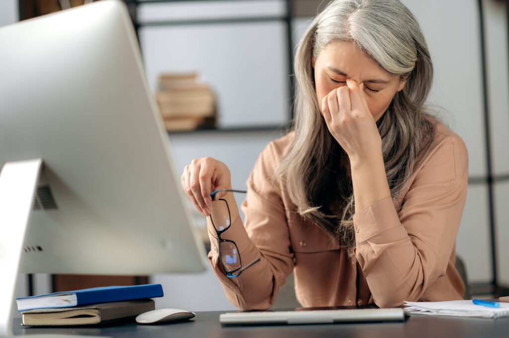 an elderly woman resting her eyes from working