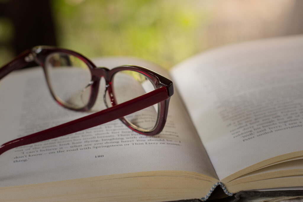 an eye glass placed on a book